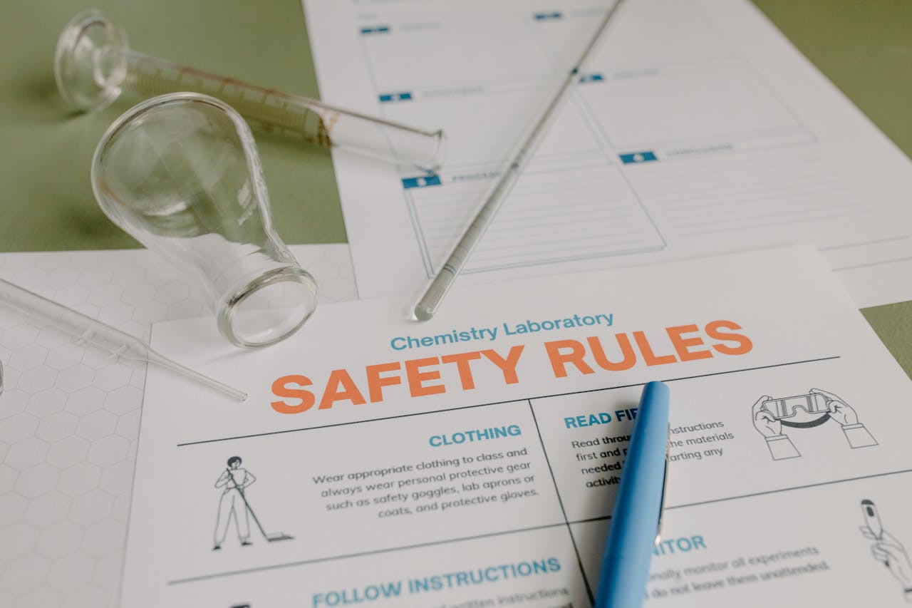 Chemistry lab setup with safety rules guidelines and glass equipment.